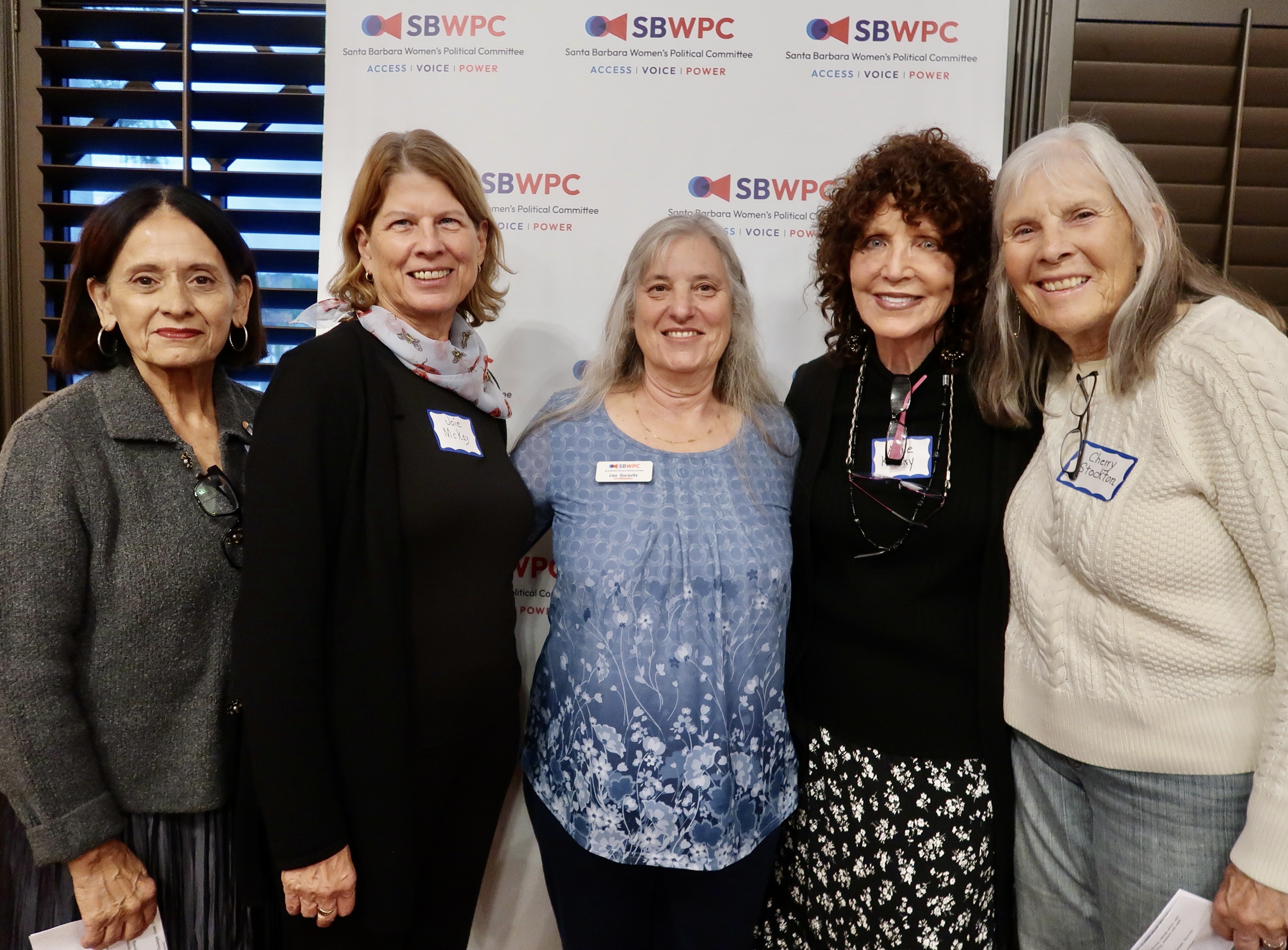 People smiling at the Cosmopolitics 2025 event